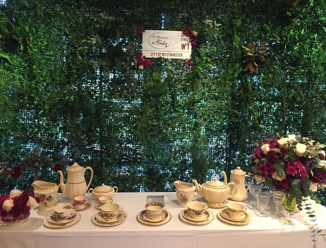 Exhibición de juegos de té antiguos de El Almacén de Andy sobre pared verde